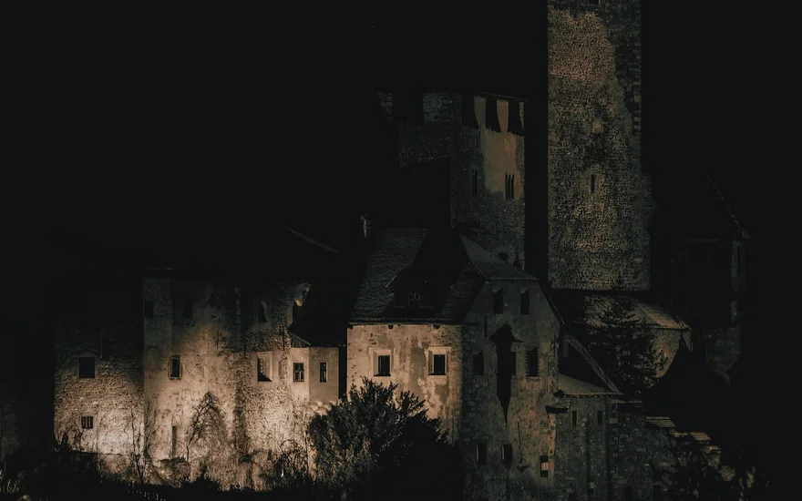 A fortress lit at night