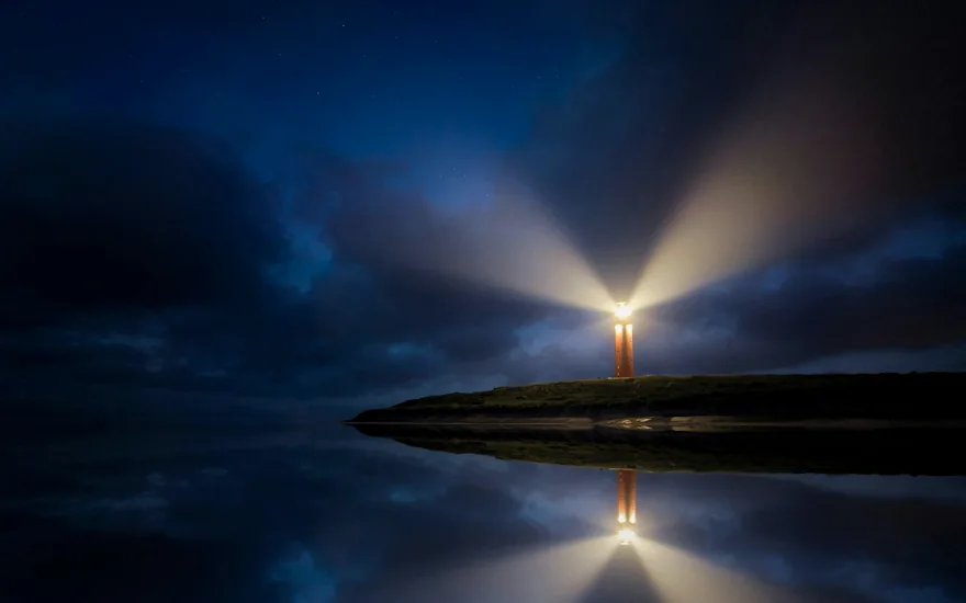 A lighthouse beam over dark water